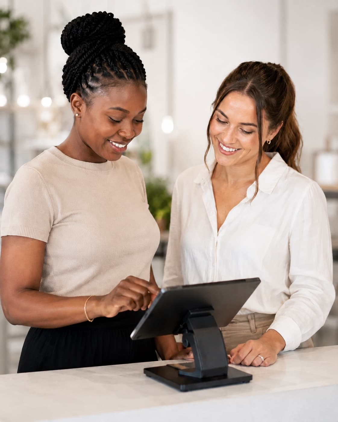 Two YesChef vendors checking an order together on the counter tablet