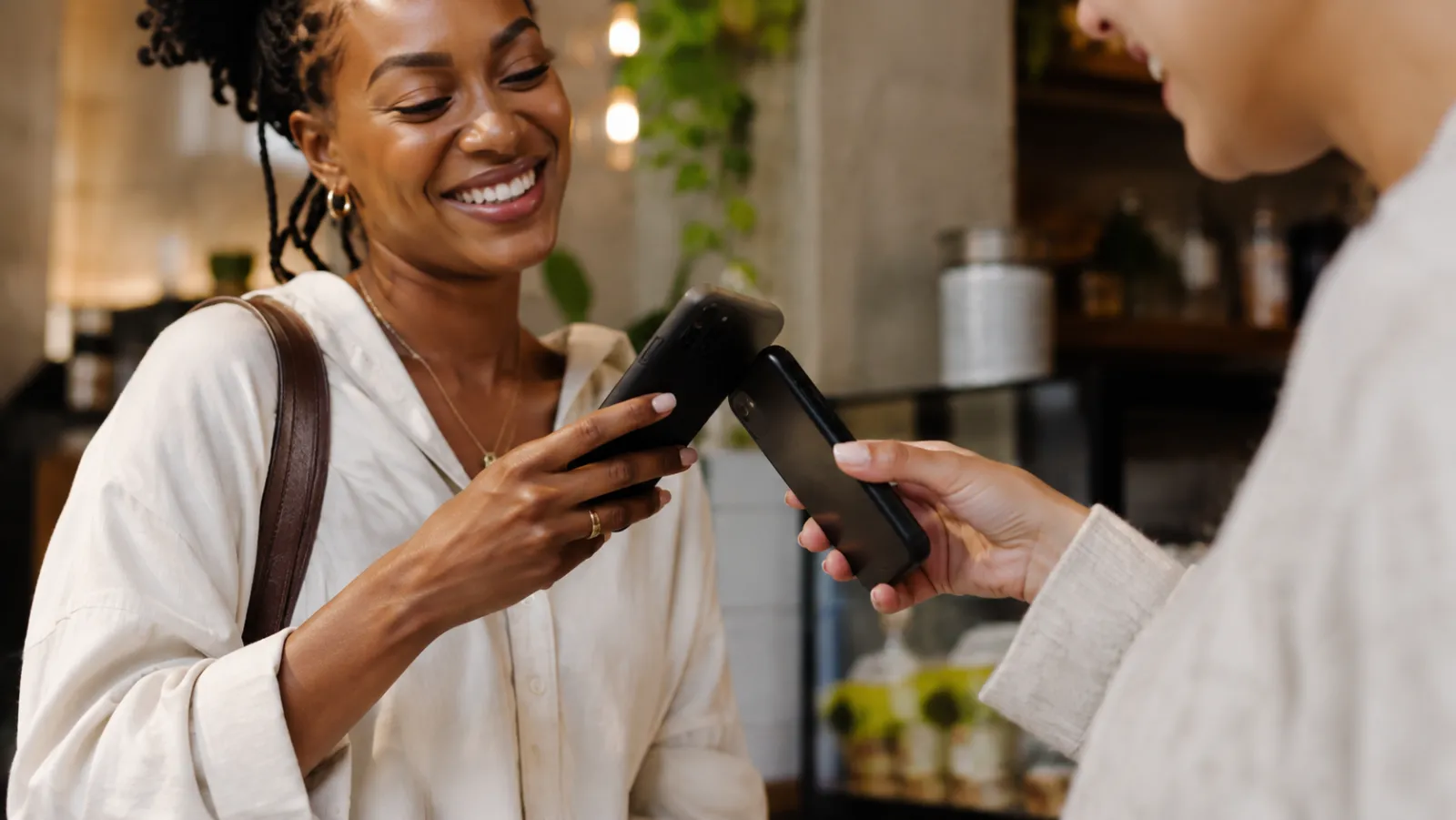 A customer ordering from her phone at a stall counter